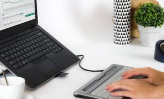 Hands typing on a keyboard