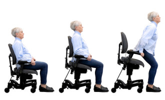 Vela Tango 700 sit to stand chair showing an adult using the chair